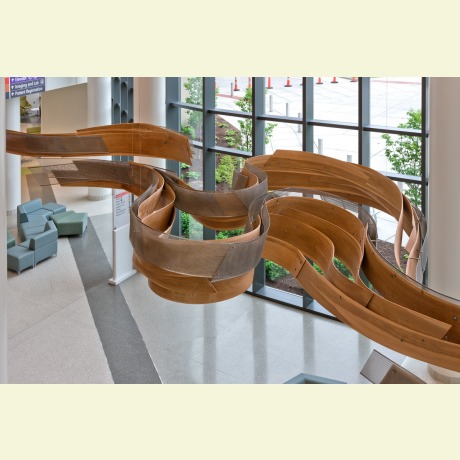 Bent laminated wood and metal sculpture. Bent lamination of wood accomplished with a vacuum press